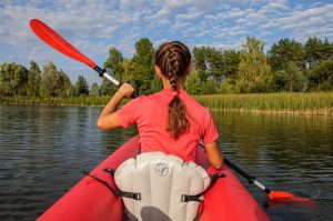 A,Young,Woman,In,Bright,Clothes,Floats,On,A,Red